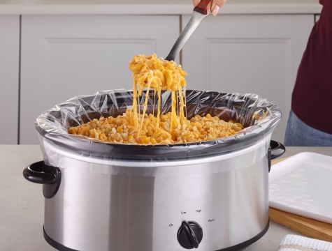 Slow cooker with a liner inside filled with mac & cheese