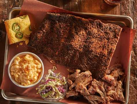 smoked meats and sides on a butcher paper lined tray