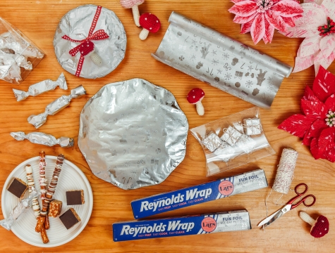 Holiday candies and plates wrapped in Reynolds Wrap Fun Foil