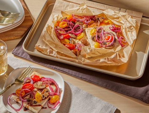 tofu in an open parchment cooking bag at a set table