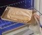 person removing a sealed parchment cooking bag from the oven
