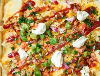 BBQ roasted nachos on an aluminum foil lined baking sheet