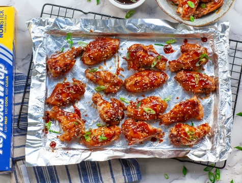 Baked teriyaki chicken wings on a foil lined baking sheet